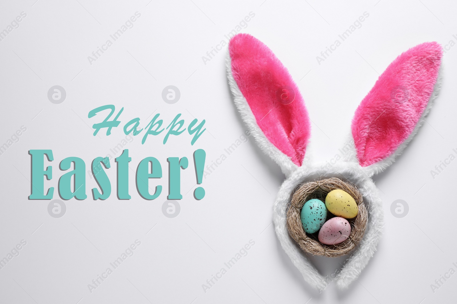 Image of Easter bunny ears headband and dyed eggs in nest on white background, flat lay