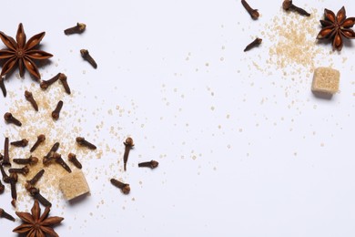 Different spices on white table, flat lay. Space for text