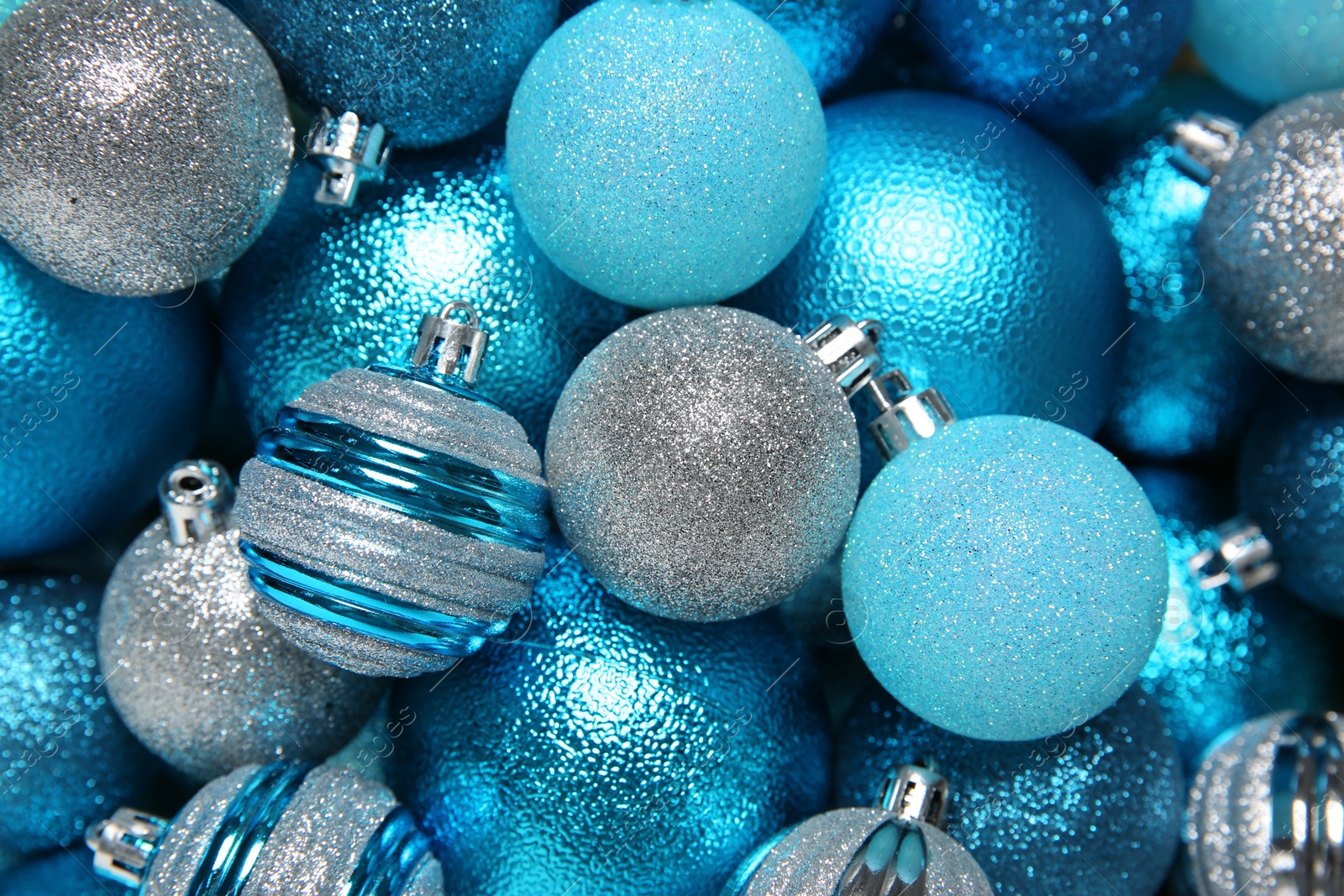 Photo of Bright Christmas balls as background, top view