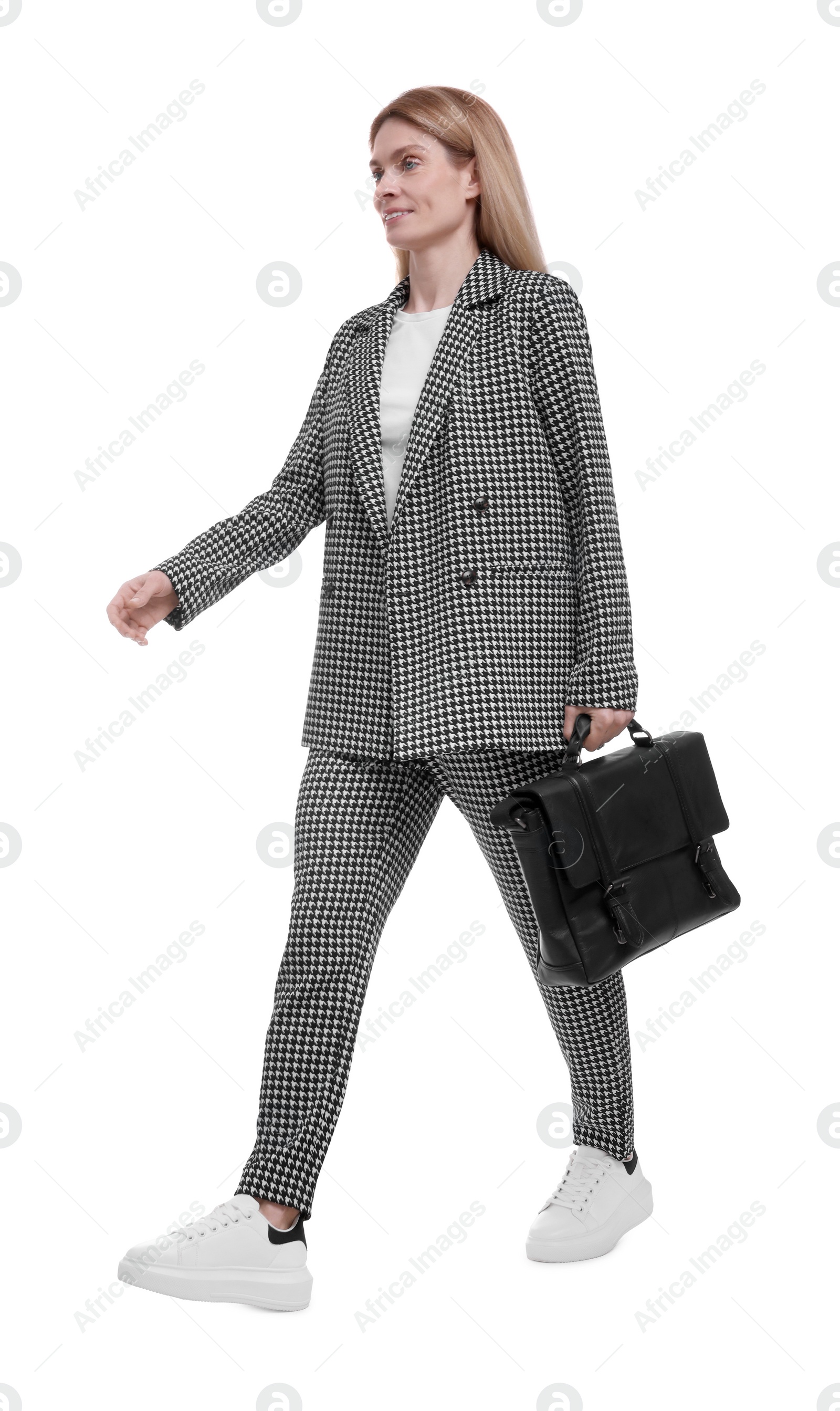 Photo of Beautiful happy businesswoman in suit with briefcase walking on white background