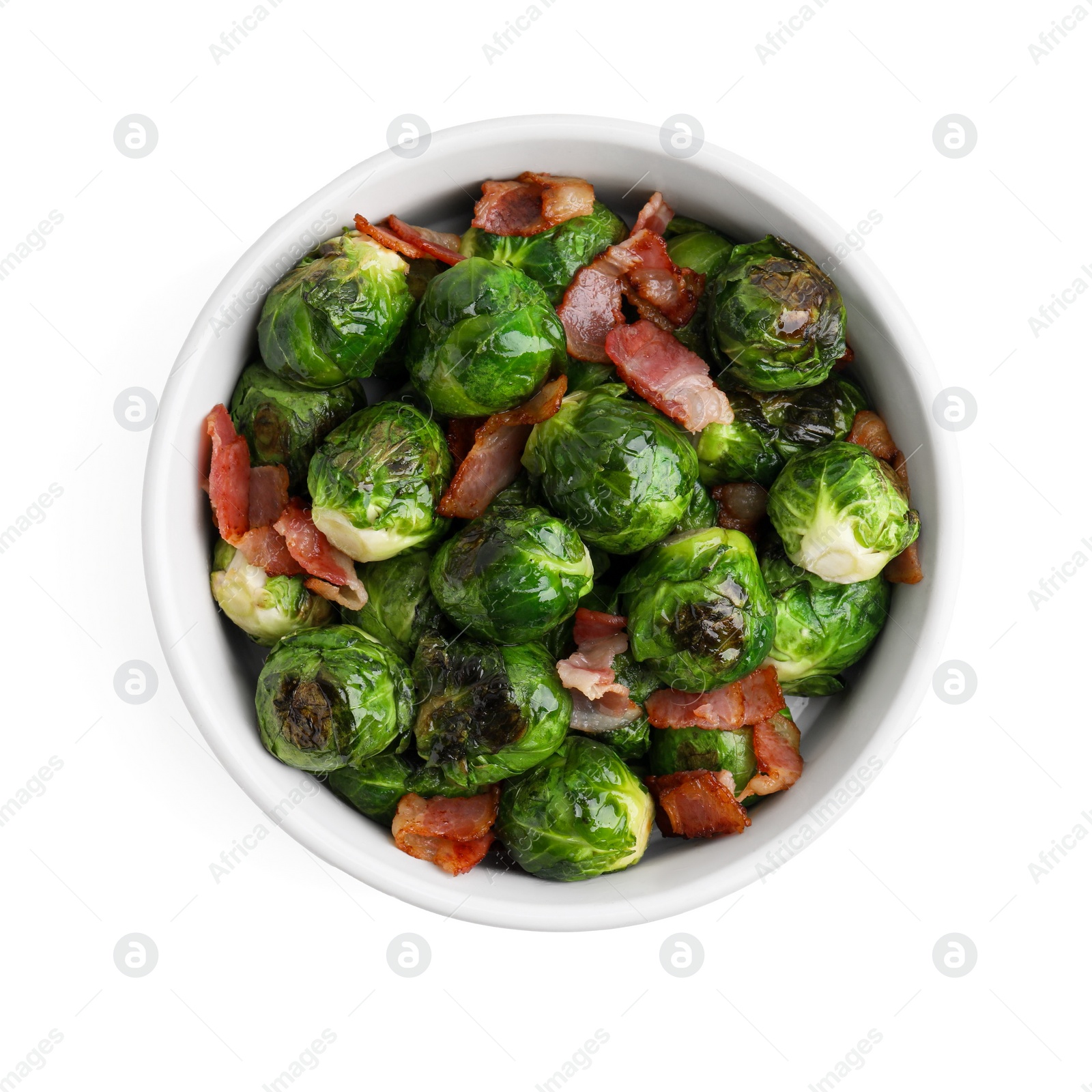 Photo of Delicious roasted Brussels sprouts and bacon in bowl isolated on white, top view