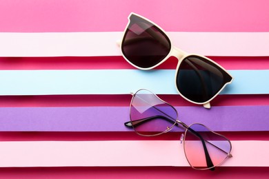 Different stylish sunglasses on color background, flat lay. Space for text