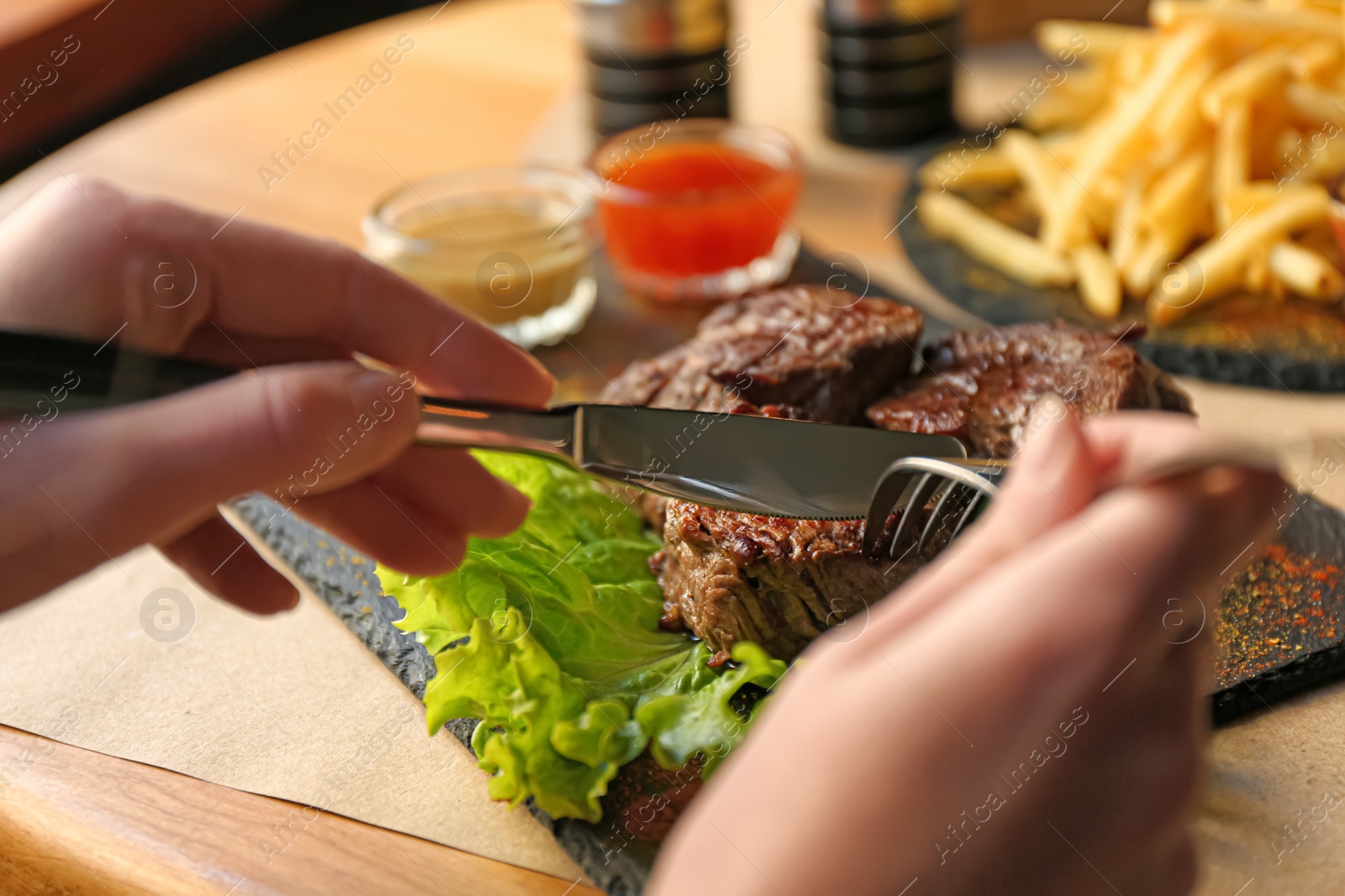 Photo of Woman eating tasty shish kebab in cafe