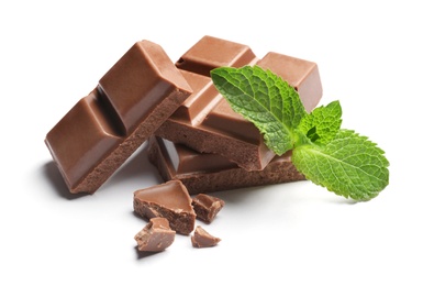 Pieces of milk chocolate with mint on white background