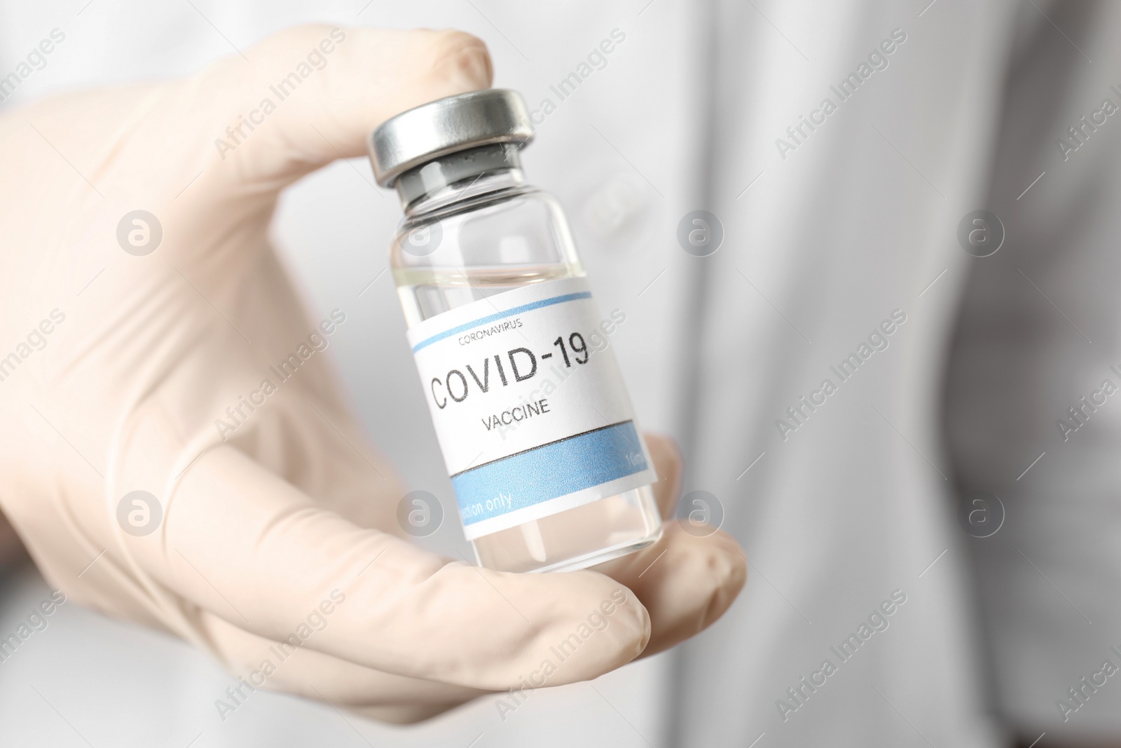 Photo of Doctor holding vial with vaccine against Covid-19, closeup