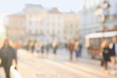 Photo of Blurred view of people walking on city street