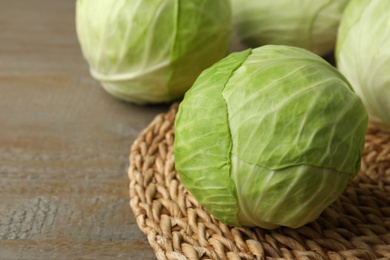 Photo of Ripe white cabbage on wooden table, closeup