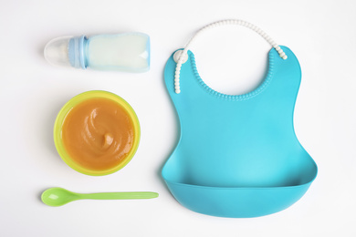 Photo of Flat lay composition with baby food and accessories on white background