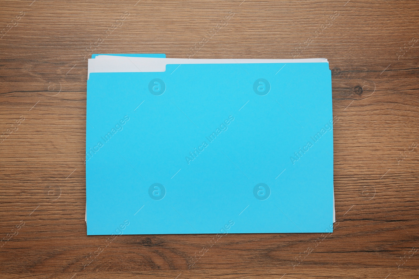 Photo of Turquoise file with documents on wooden table, top view