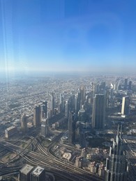 Dubai, United Arab Emirates - May 2, 2023: Picturesque view of city with skyscrapers from Burj Khalifa