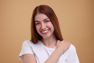 Photo of Portrait of smiling woman on beige background