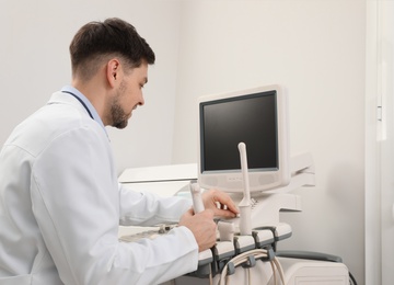 Photo of Sonographer operating modern ultrasound machine in clinic