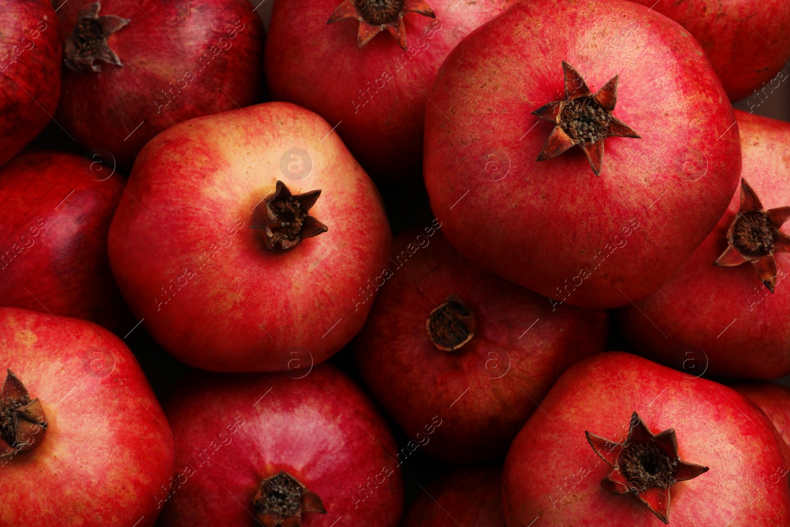 Photo of Fresh ripe pomegranates as background, top view