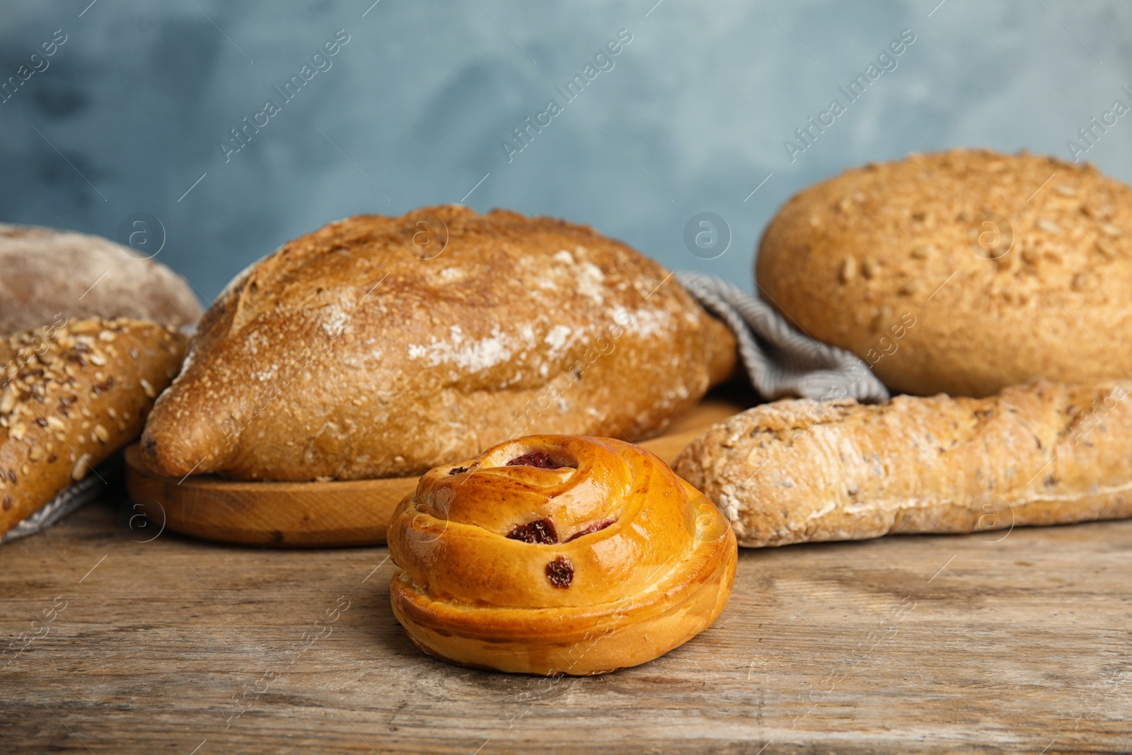 Photo of Fresh breads and pastry on wooden table