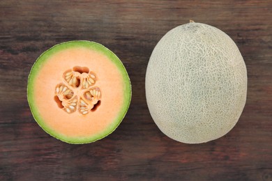 Whole and cut fresh ripe melons on wooden table, flat lay