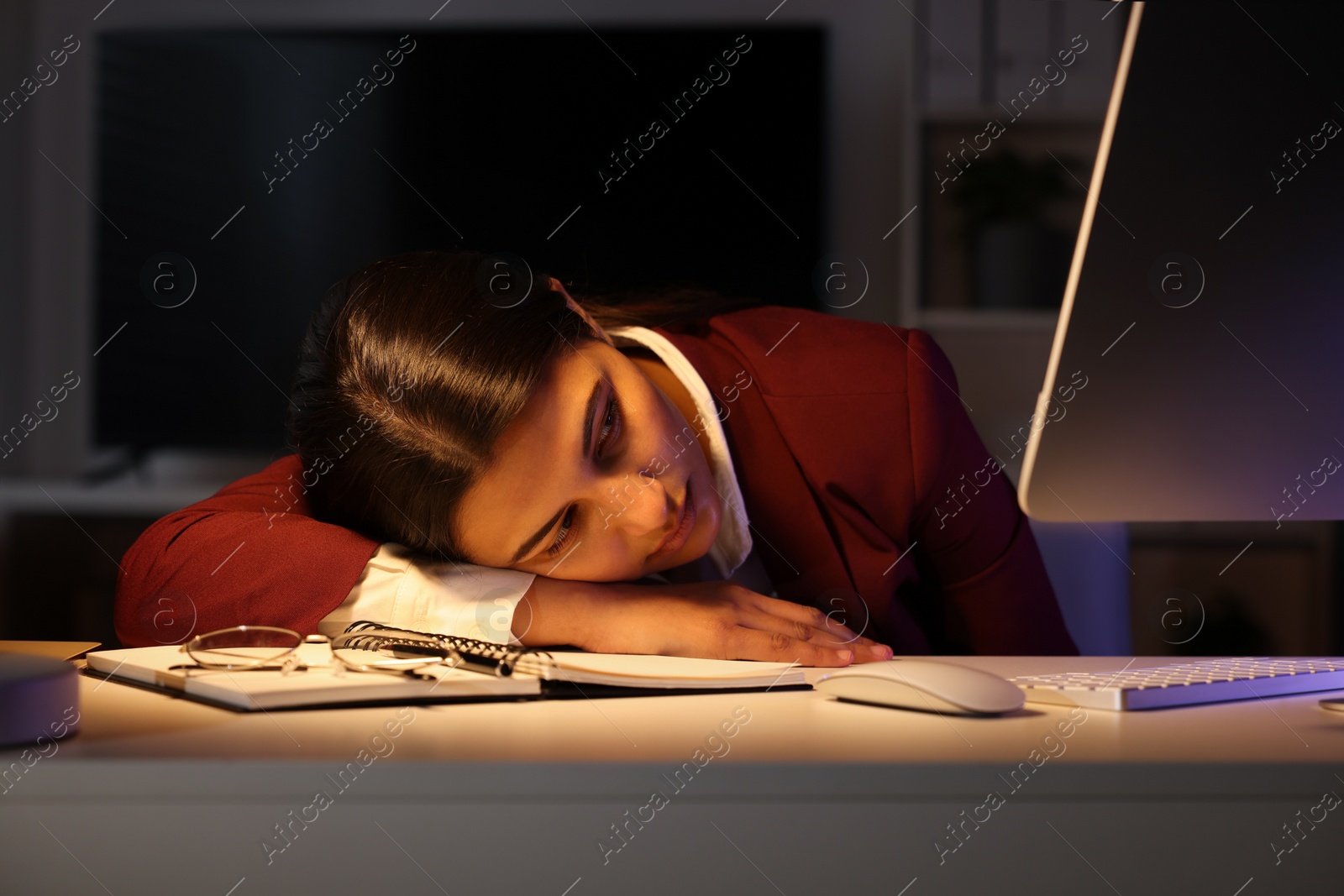 Photo of Tired overworked businesswoman at table in office