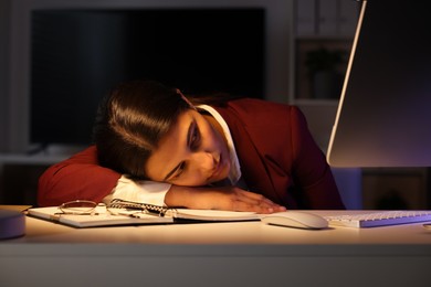 Photo of Tired overworked businesswoman at table in office