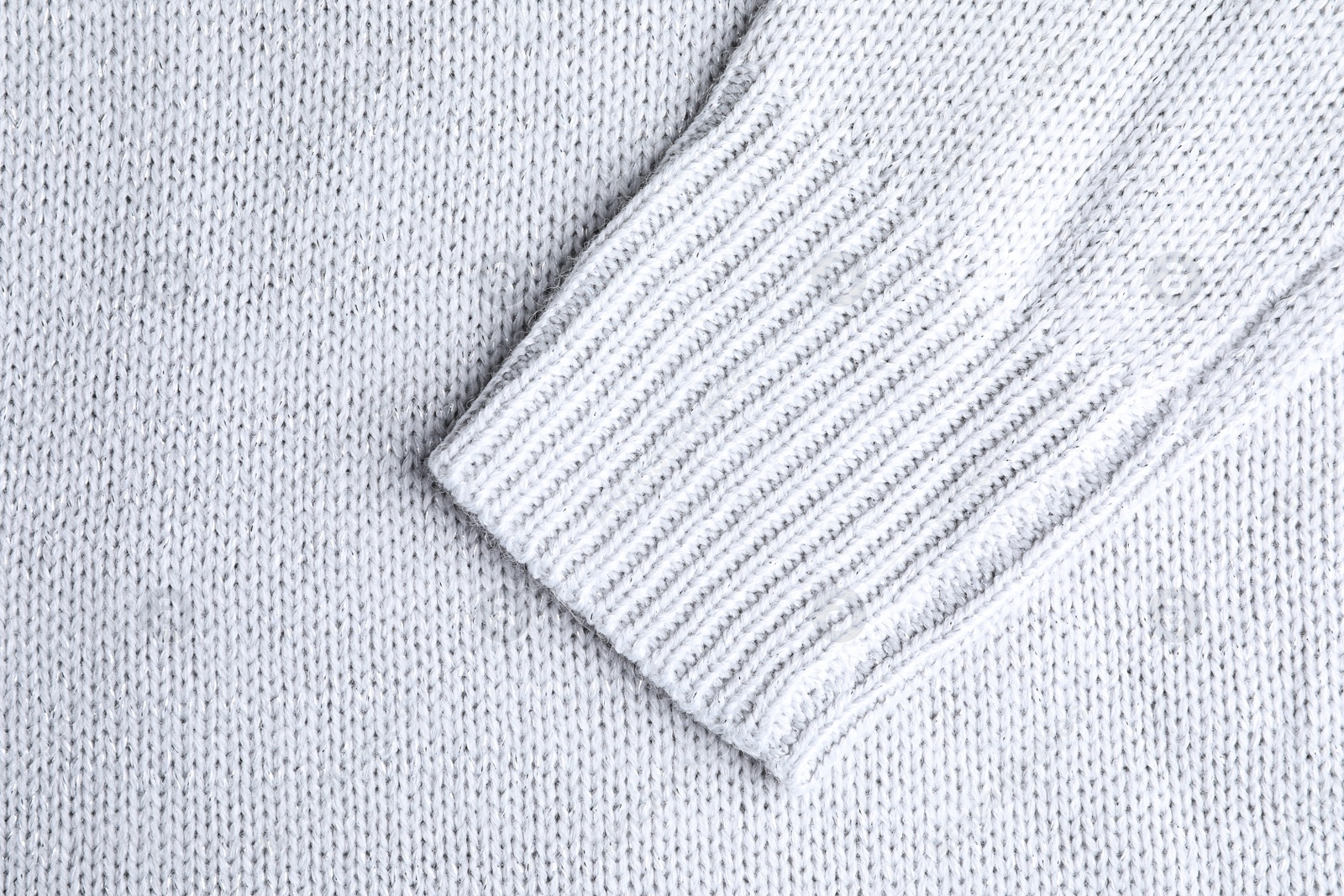 Photo of Warm knitted sweater as background, closeup view