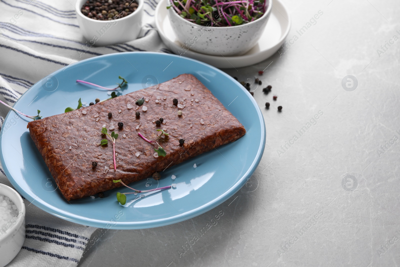 Photo of Fresh raw vegan mince with spices on light grey marble table. Space for text