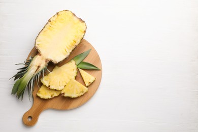 Ripe juicy pineapple on white wooden table, top view. Space for text