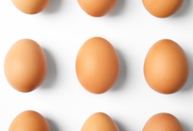 Raw chicken eggs on white background, top view