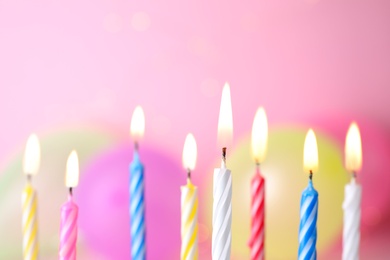 Burning birthday cake candles on color background. Space for text