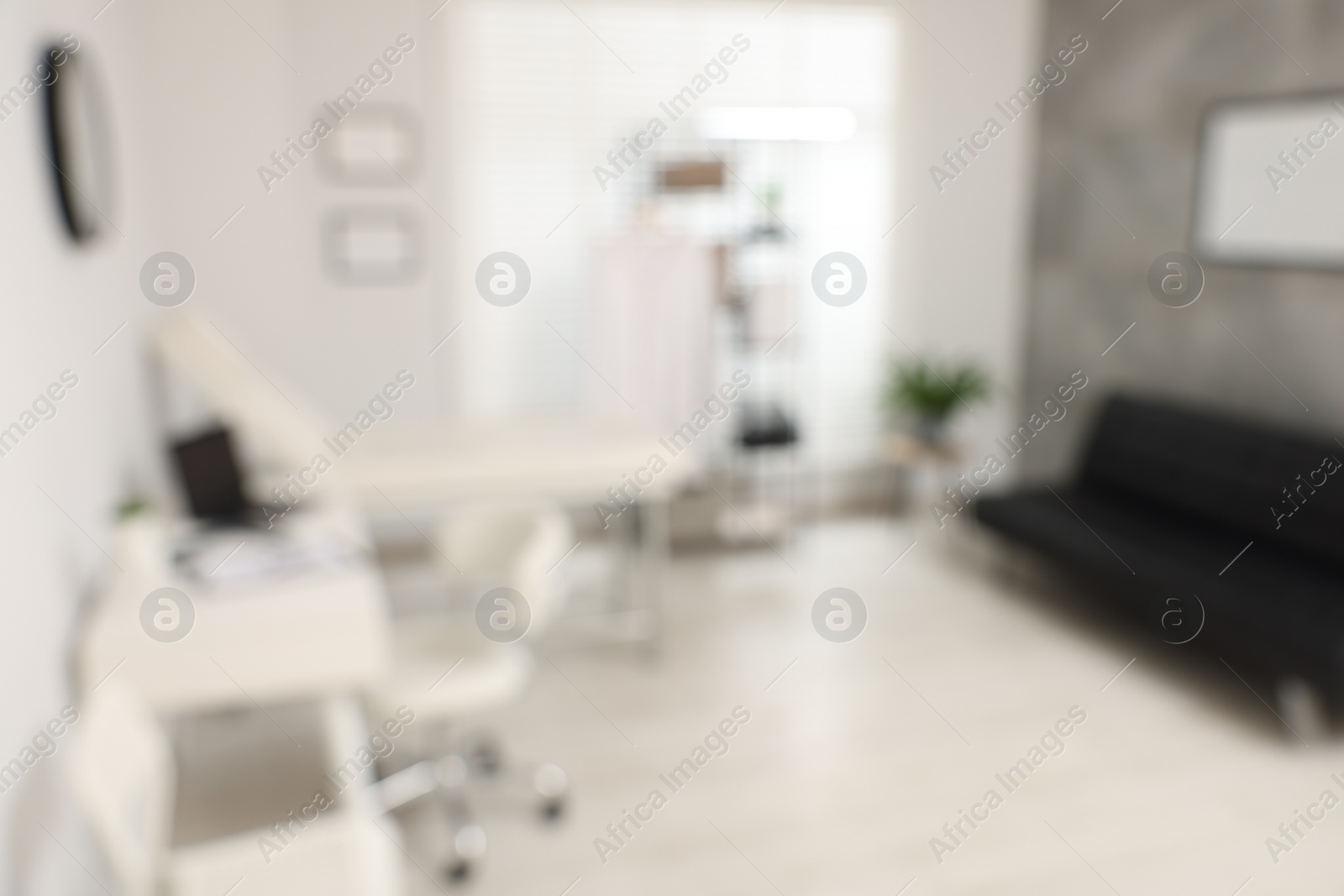 Photo of Blurred view of modern medical office with doctor's workplace in clinic