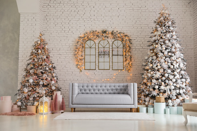 Beautiful interior of living room with decorated Christmas trees