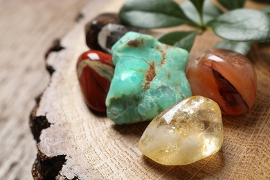 Citrine quartz and beautiful gemstones on wooden stand, closeup