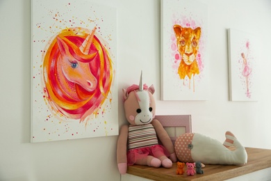 Photo of Cute pictures and toys in baby room interior