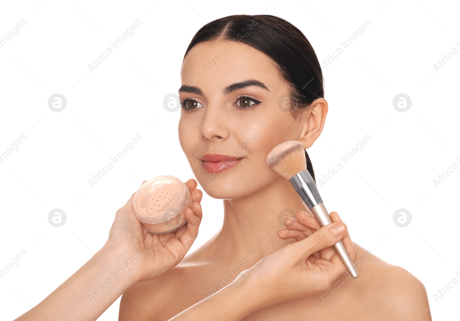 Photo of Professional makeup artist applying powder onto beautiful young woman's face with brush on white background