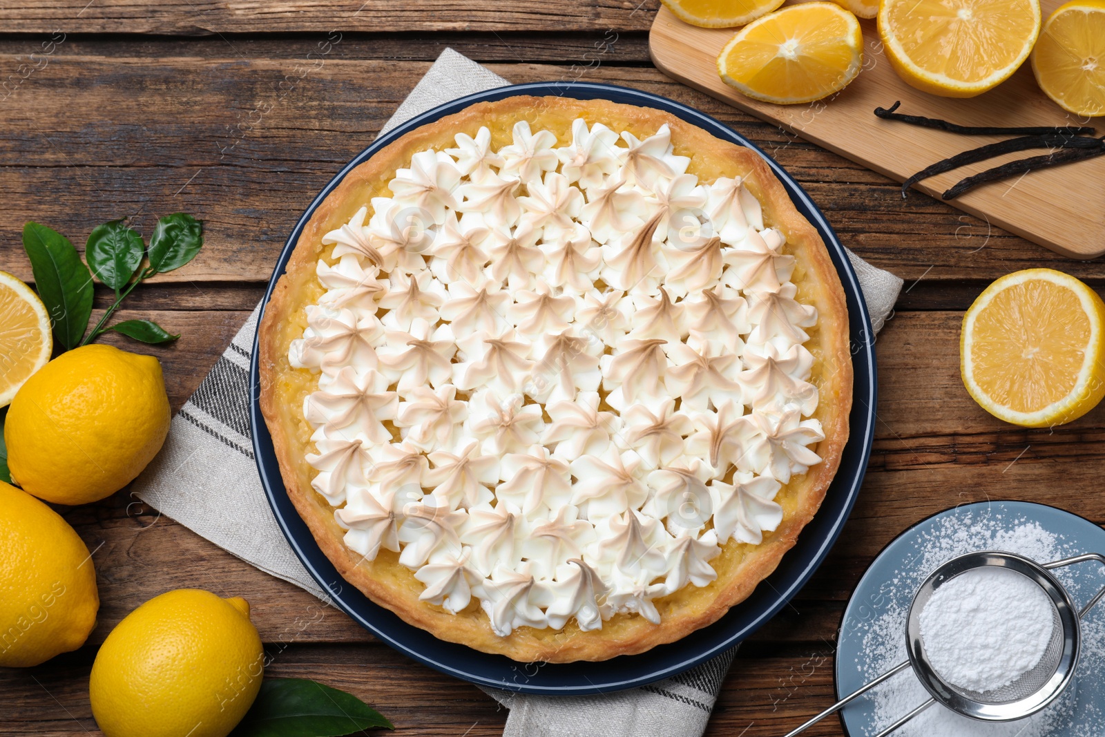 Photo of Flat lay composition with delicious lemon meringue pie on wooden table