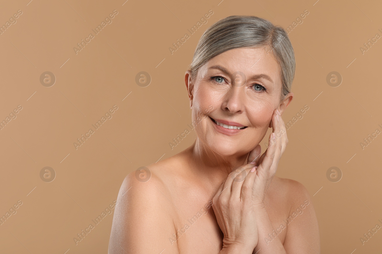 Photo of Beautiful mature woman with healthy skin on beige background, space for text