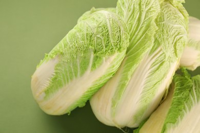 Photo of Fresh ripe Chinese cabbages on olive background, closeup