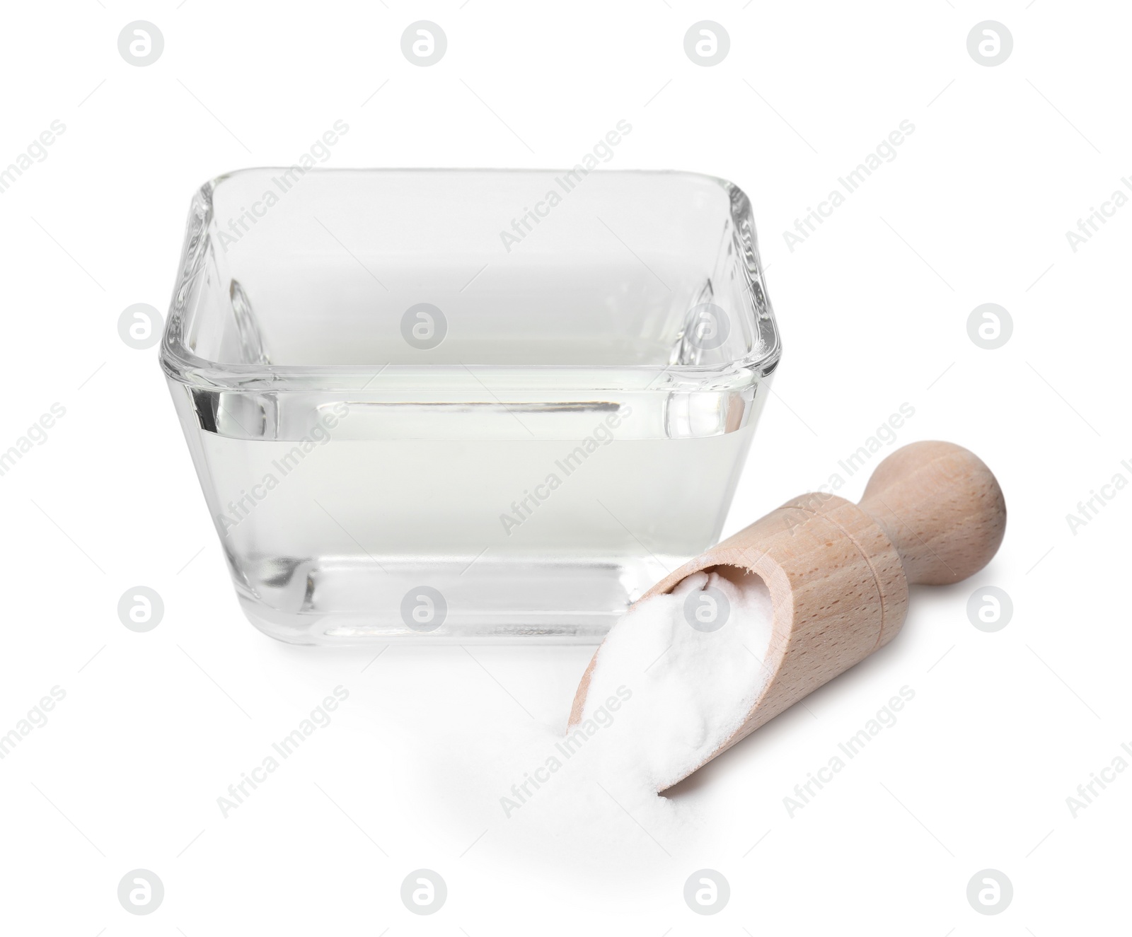 Photo of Vinegar in glass bowl, baking soda and wooden scoop isolated on white