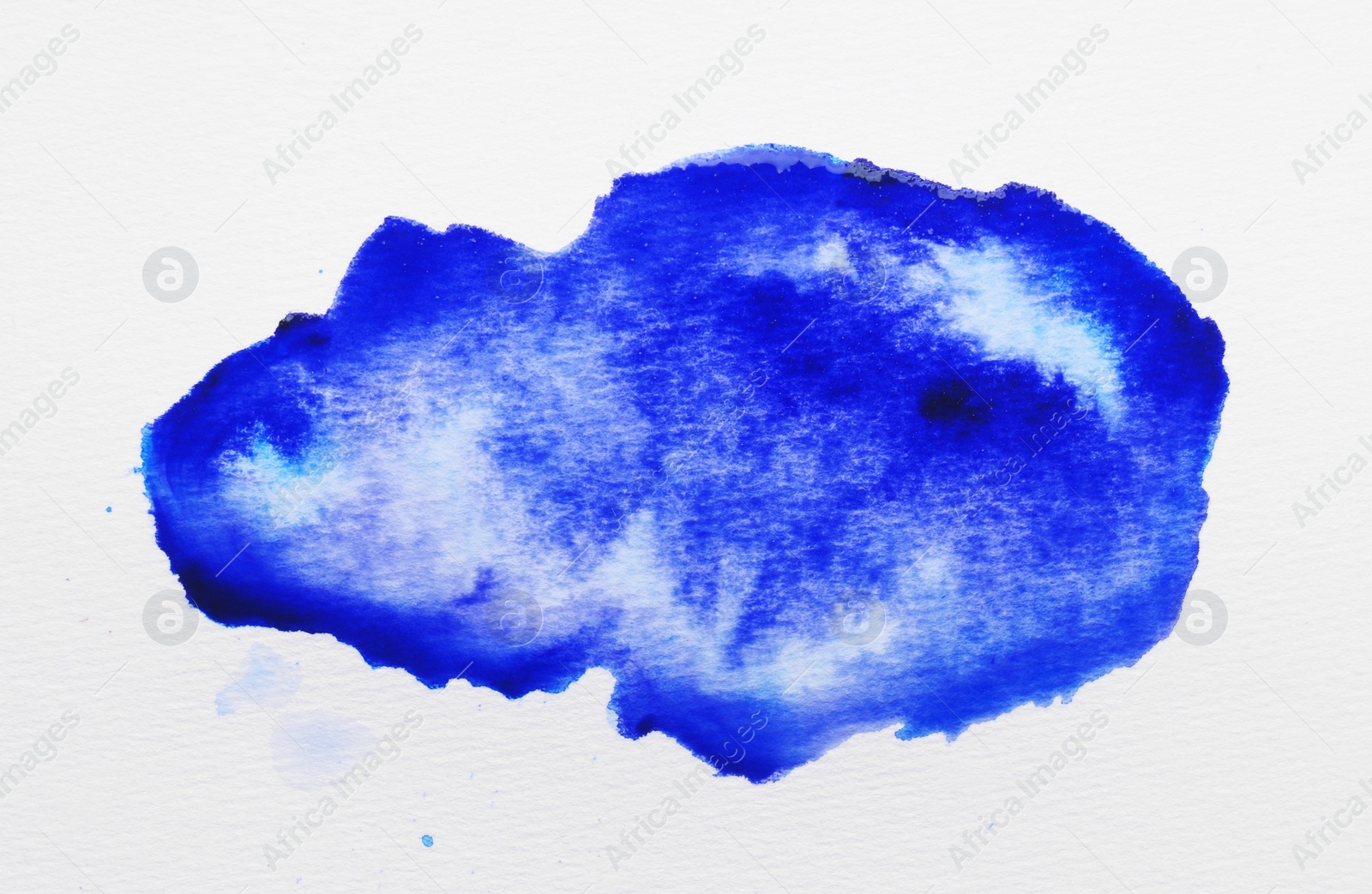 Photo of Blot of blue ink on white background, top view