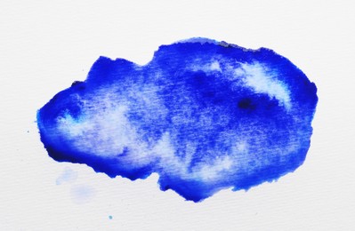 Photo of Blot of blue ink on white background, top view