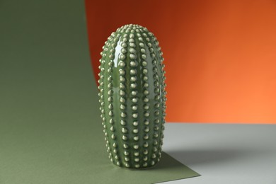 Photo of One beautiful ceramic cactus on color background