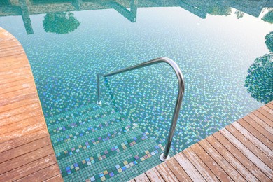 Photo of Outdoor swimming pool with steps and rail at resort