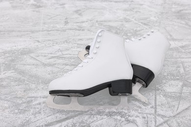 Pair of white figure skates on ice