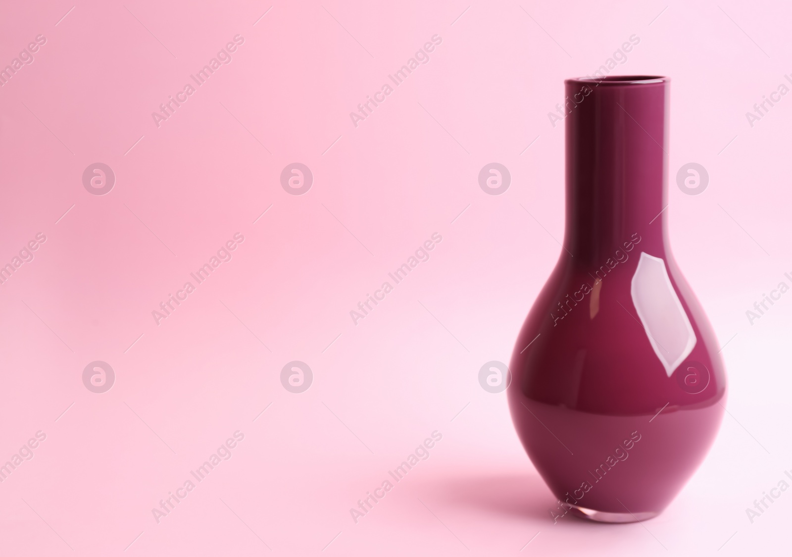 Photo of Stylish empty ceramic vase on pink background, space for text