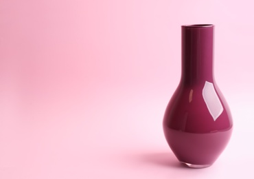 Stylish empty ceramic vase on pink background, space for text