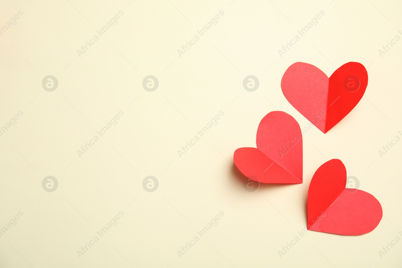 Photo of Small paper hearts on color background