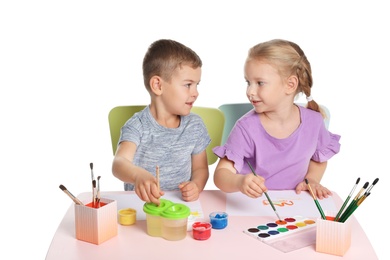 Cute children painting picture at table on white background