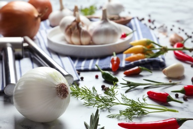 Photo of Composition with onion, pepper, dill and garlic on kitchen table