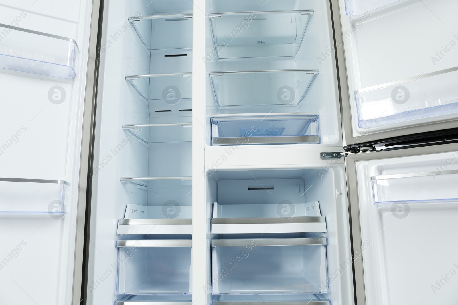 Photo of Shelves of empty modern refrigerator, closeup view