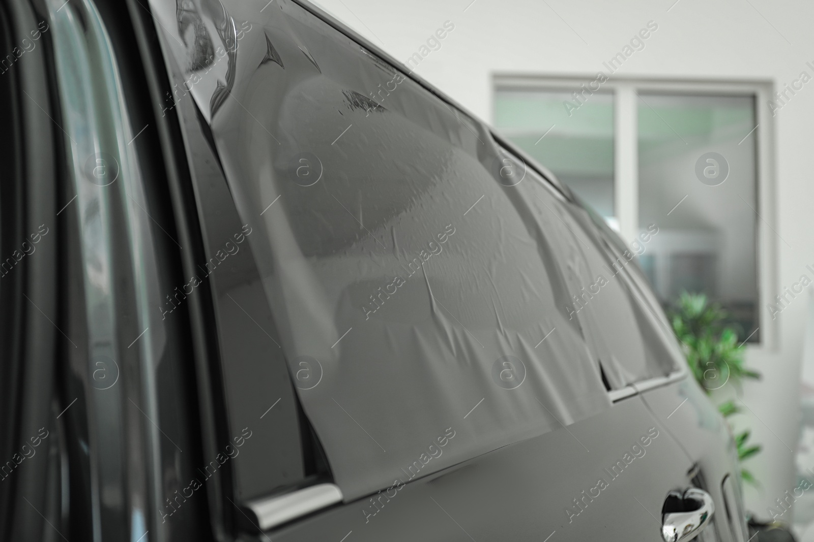 Photo of Car window covered with tinting foil, closeup