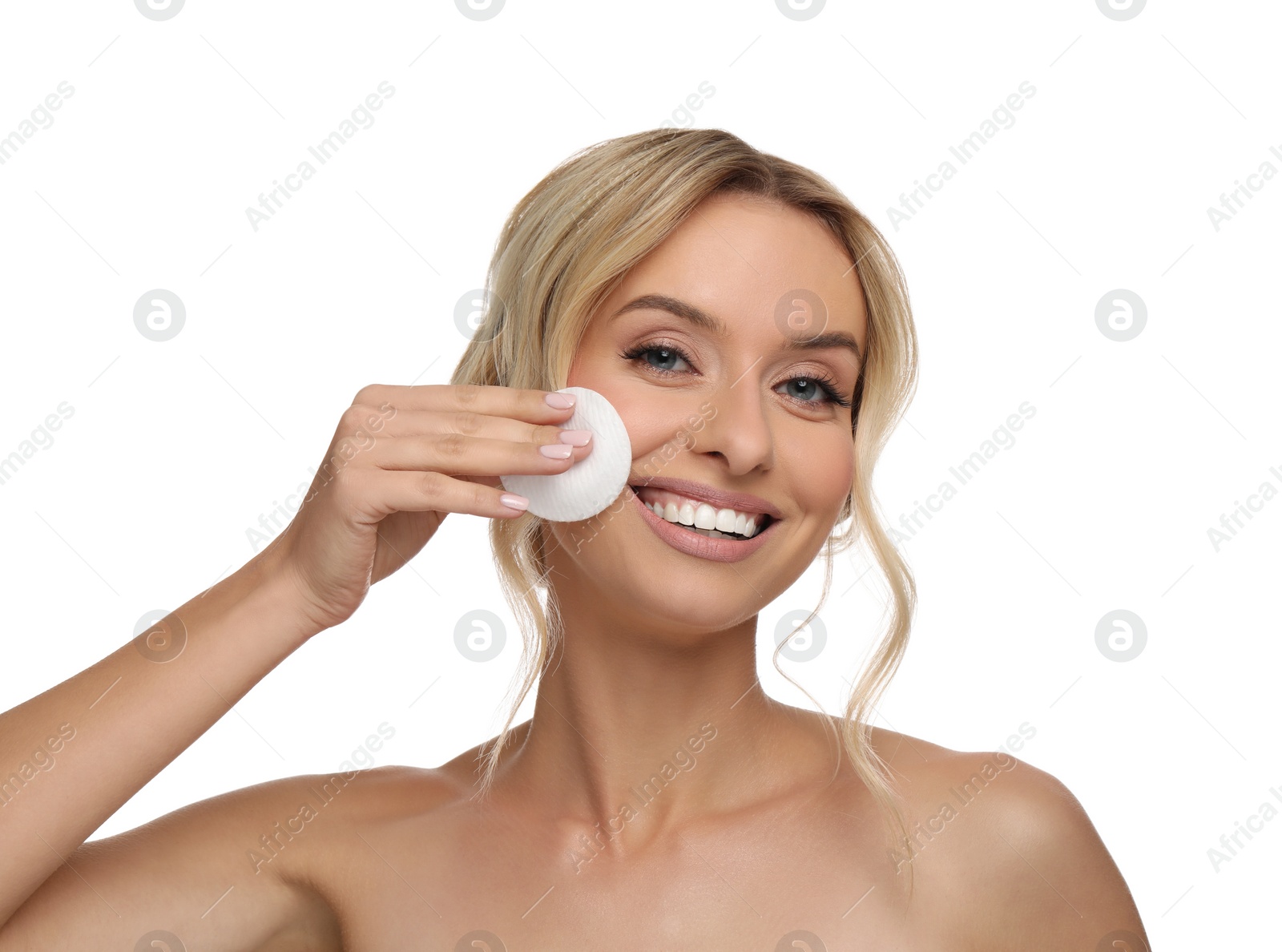 Photo of Smiling woman removing makeup with cotton pad on white background