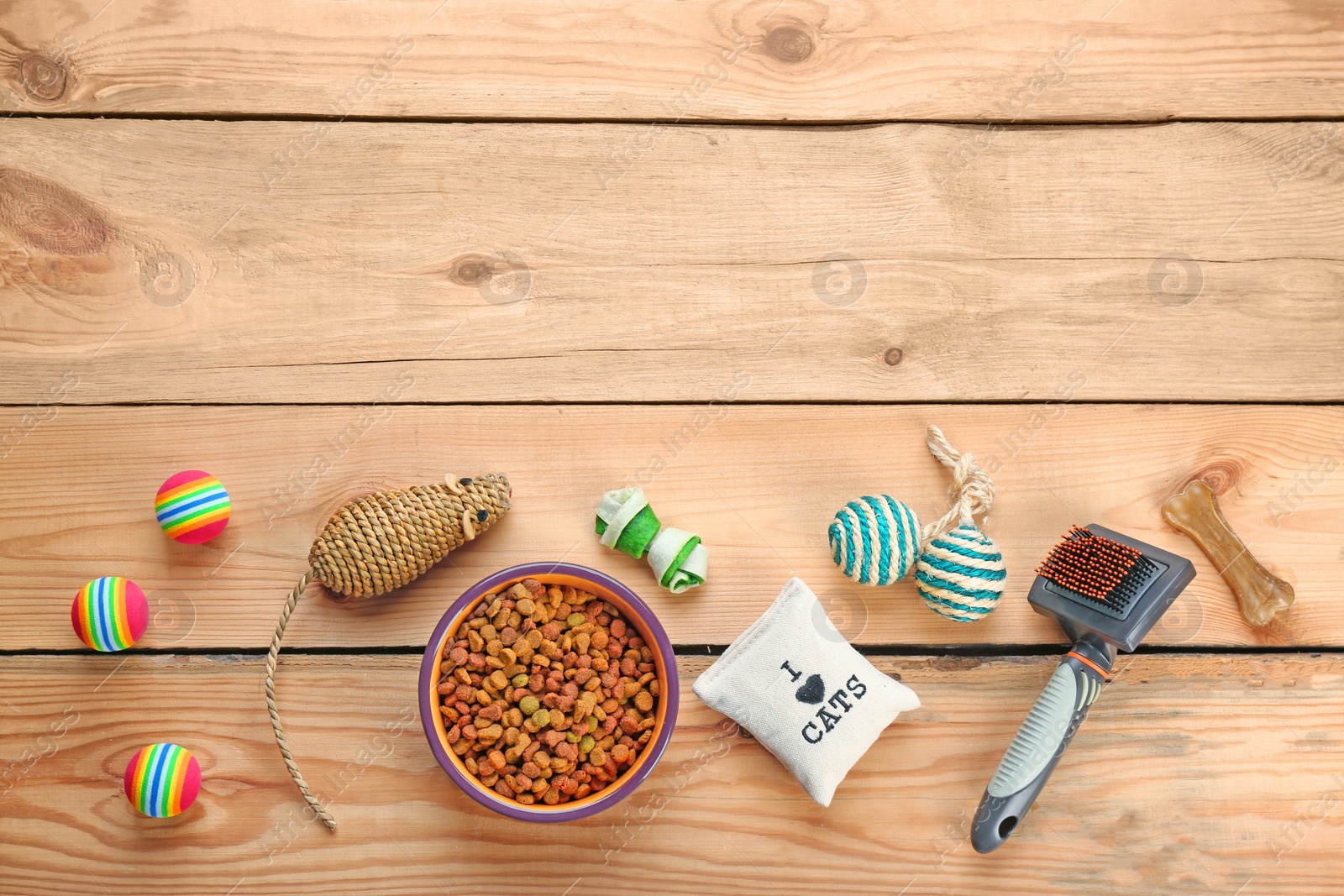 Photo of Flat lay composition with cat accessories and food on wooden background