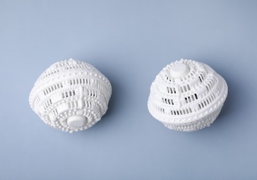 Dryer balls for washing machine on light grey background, flat lay